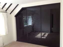 Black glass doors with a floral pattern on the middle door