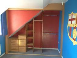 A custom built wardrobe interior built to maximise the use of an awkward space