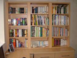 Bookcase fitted ontop of a corner desk