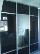 Black glass wardrobe with a mirror centeral mirror